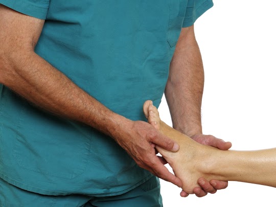 podiatrist examining foot